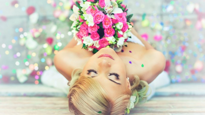 Beautiful blonde bride with a bouquet of flowers
