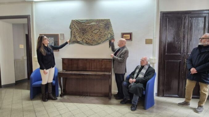 Il professore Pino Nania consegna un'opera alla Scuola di Musica